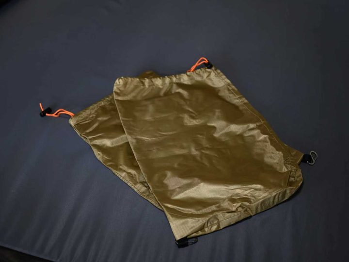 A waterproof shoe bag lying on the mattress
