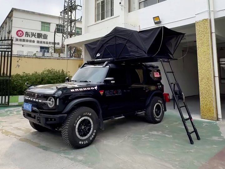 Roof tent open on a black Ford Bronco