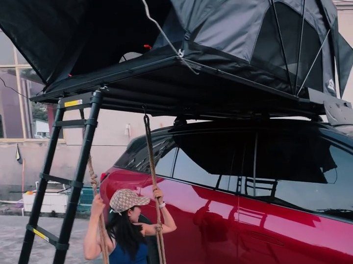 Roof tent open on a red NIO ES6 with a swing underneath