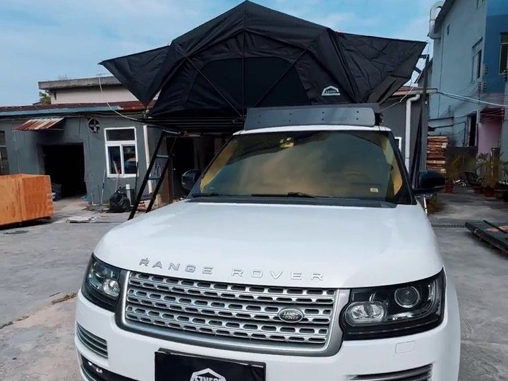 Roof tent open on a white Range Rover