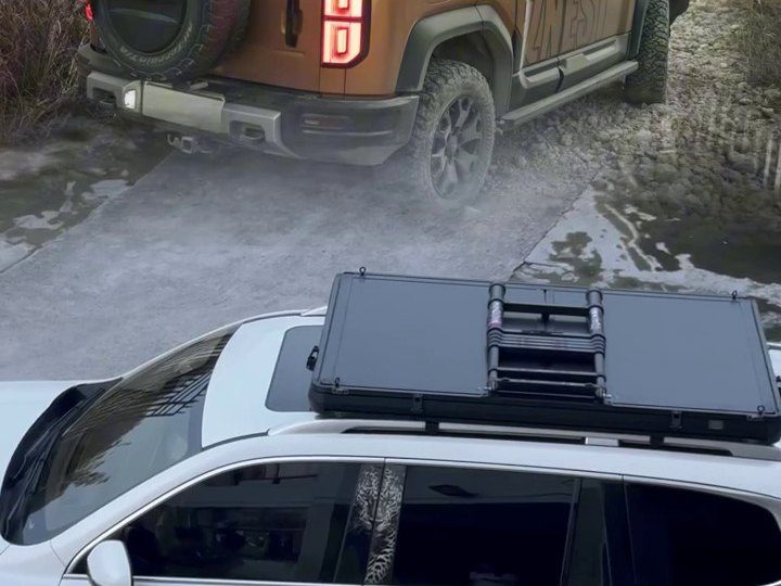 Closed roof tent seen from above on a white SUV