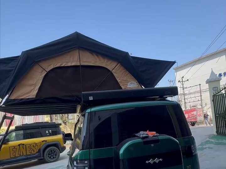 Rear of a green Fangchengbao Titanium 7 with the roof tent open