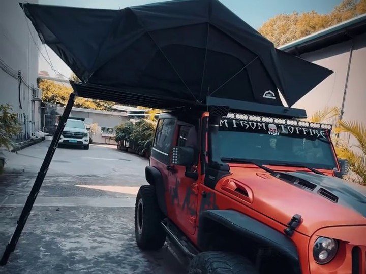 Red Jeep Wrangler with the roof tent open